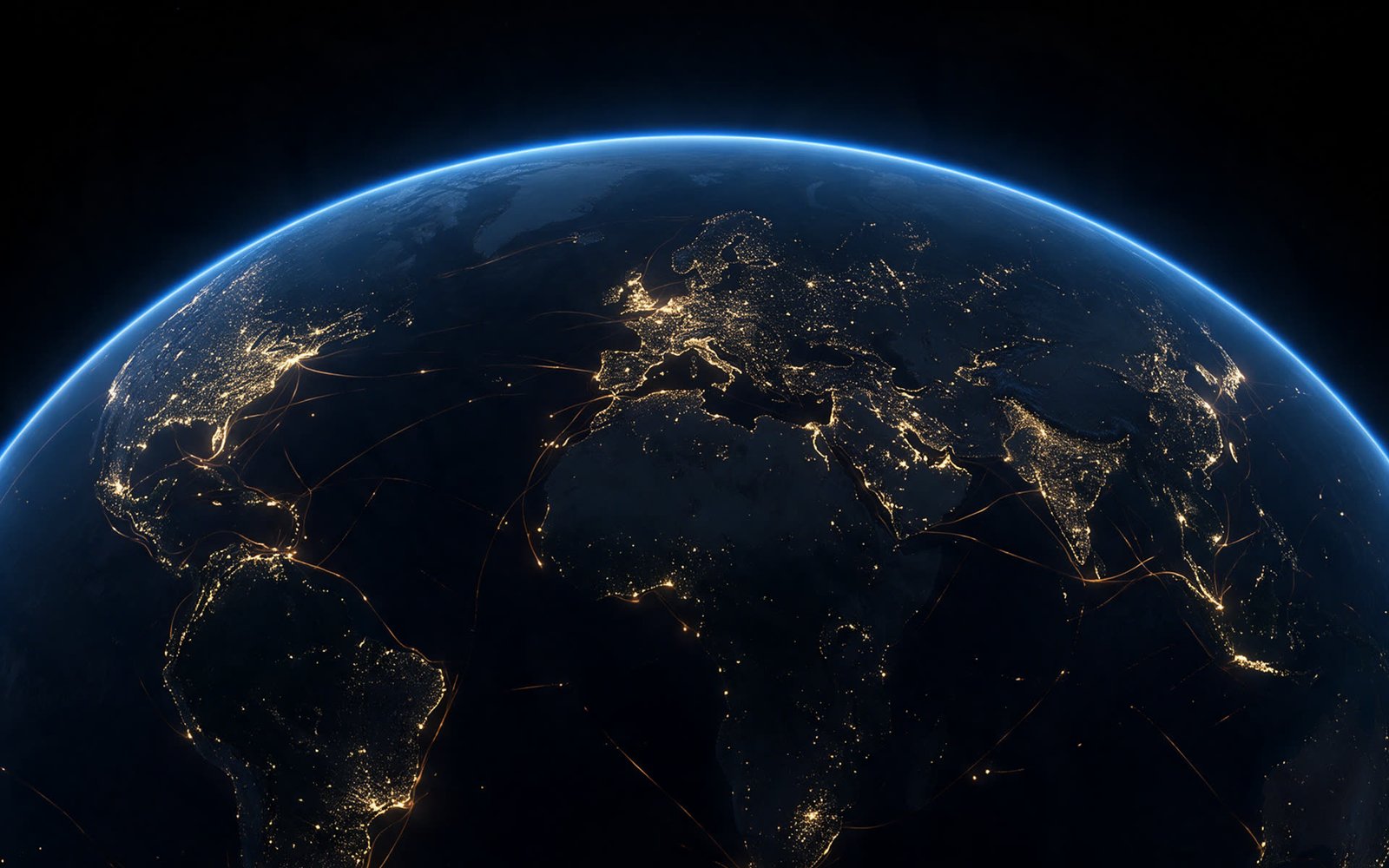 Earth at night from orbit, city lights tracing coastlines